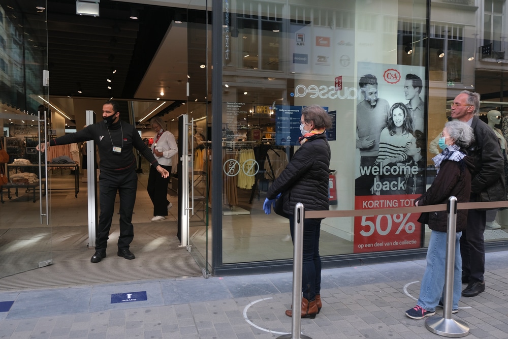 A,Security,Guard,Checks,The,People,Queue,Before,Enter,A