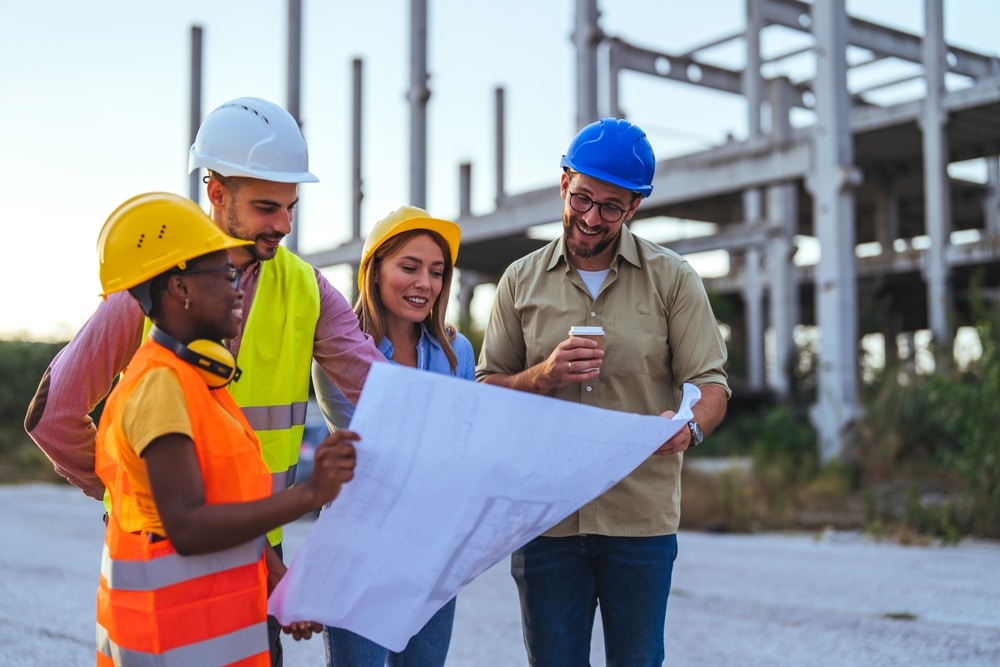 A,Multiracial,Group,Of,Construction,Professionals,In,Hard,Hats,And